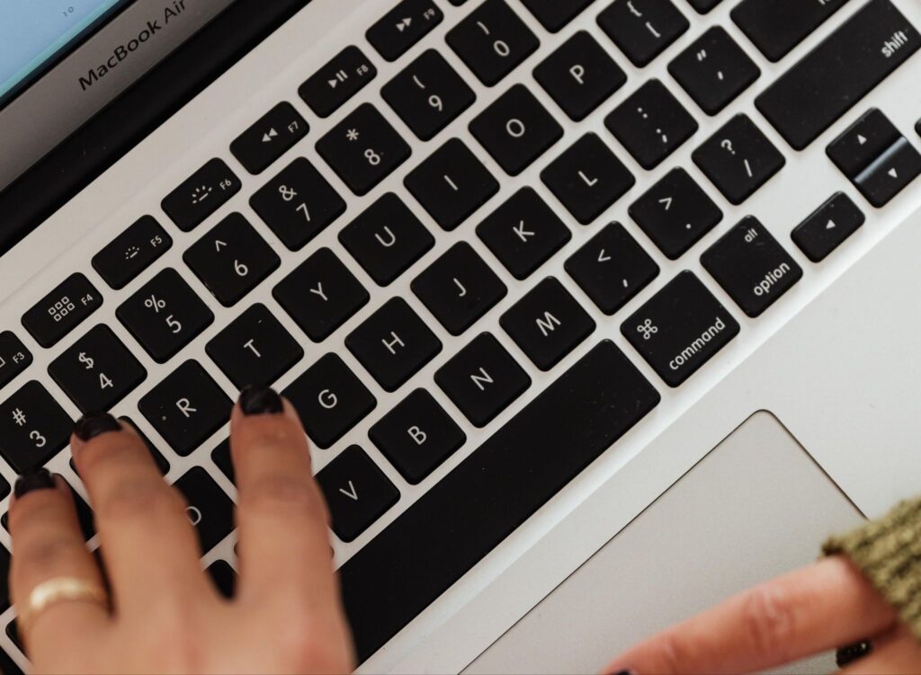 Close-up of hands typing on a MacBook Air keyboard, representing the digital content work museum staff and marketing teams do to improve search visibility and help online audiences discover museum collections.
Photo credit: Karola G via Pexels